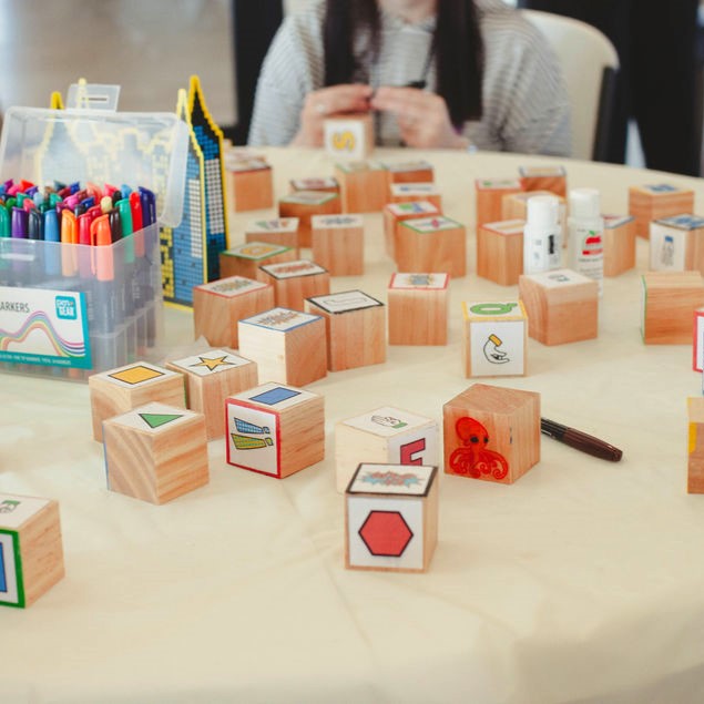 Wooden blocks with colorful labels on a table.